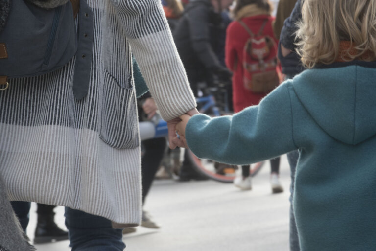 child and mother holding hands, sign of trust and intimacy